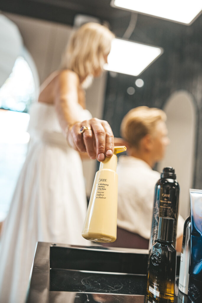 Noora Siitari working on a hairdo of a happy customer.